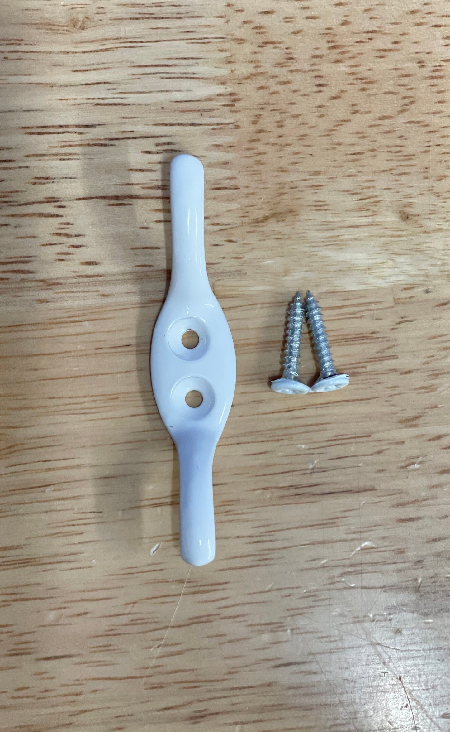 Roman blind metal cleat hook with 2 matching screws.  Available in 7 colours.