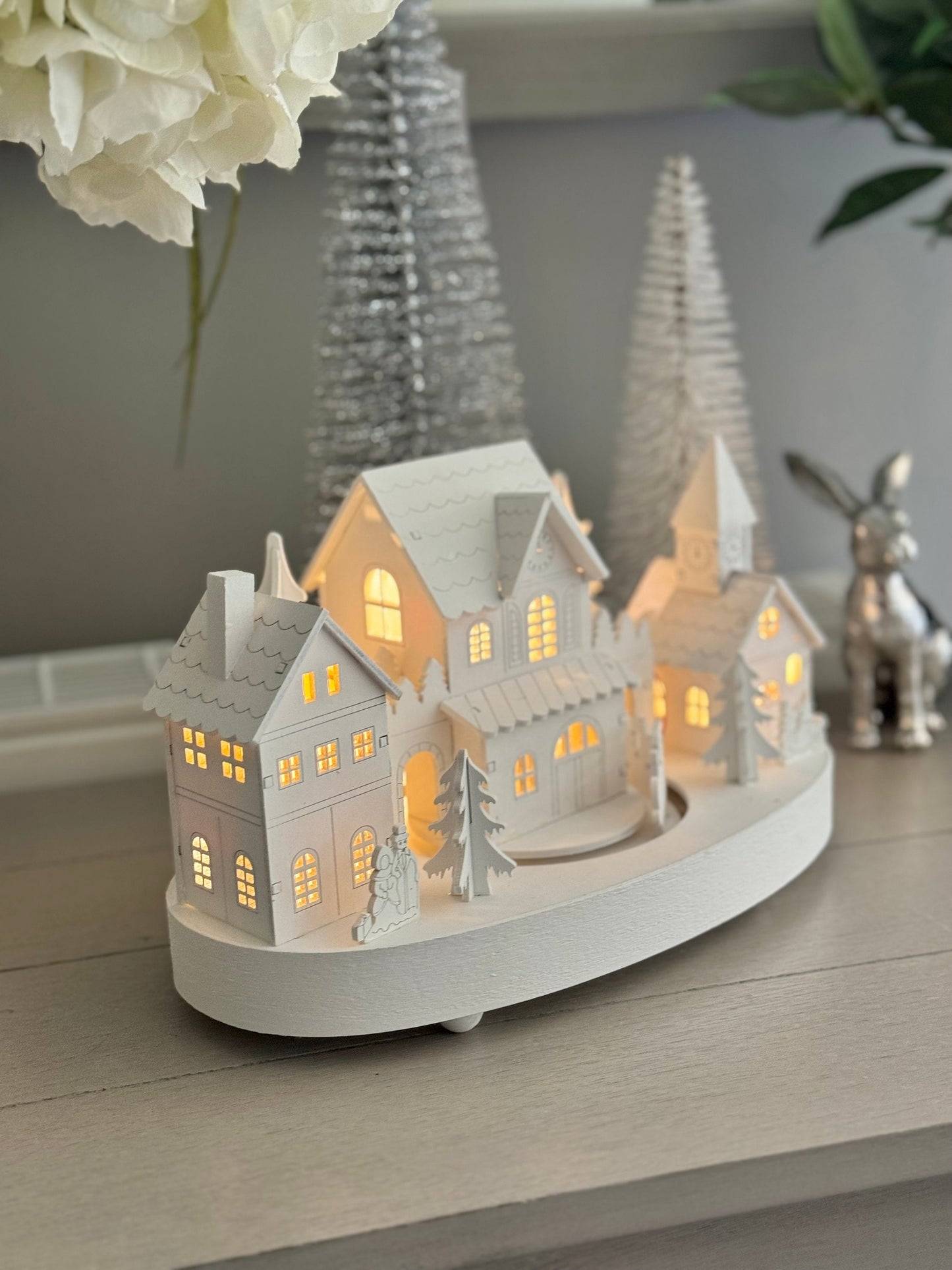 White Wooden Christmas Village Scene With Moving Train And Lights.
