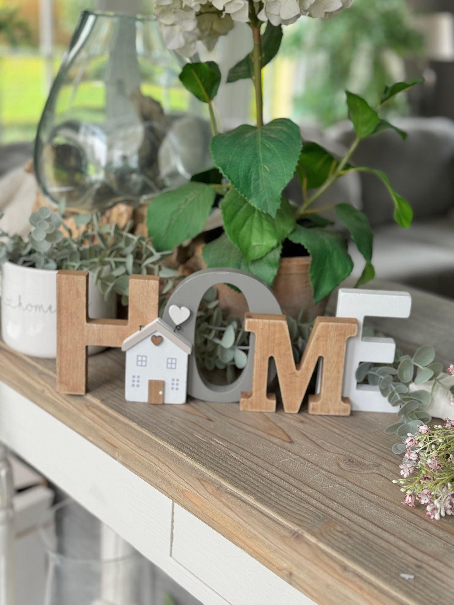 Freestanding classic wooden "HOME" sign.
