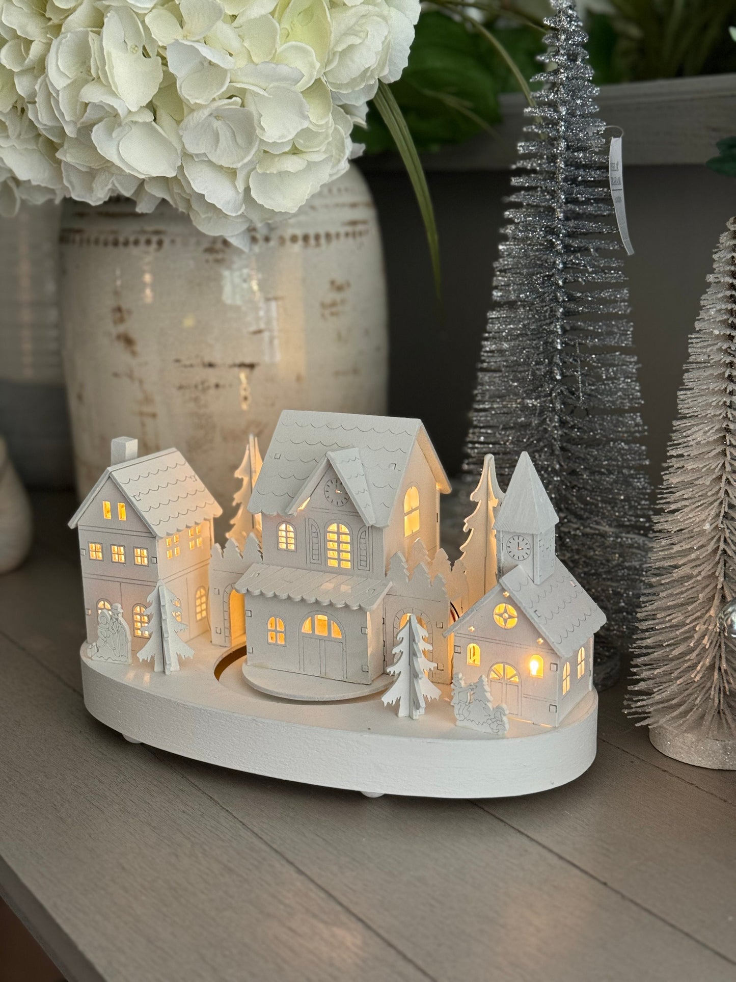 White Wooden Christmas Village Scene With Moving Train And Lights.